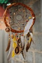 Handmade dream catcher at wall in background