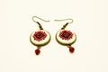 Handmade earrings with red and black romanian traditional model. Isolated on white.