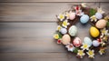 Handmade easter wreath with colored eggs and spring flowers, wood background, Royalty Free Stock Photo