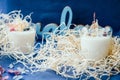 Handmade ecofriendly candle on a blue background. Natural material for aroma candles. Soya wax healthy candle with dried flowers.
