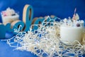 Handmade ecofriendly candle on a blue background. Soya wax healthy candle with dried flowers. Scented candles with wick. Flavored