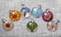 Handmade epoxy resin jewelry. pendants. in copper frame. chamomile, calendula, lobelia, hydrangea, rose, delphinium, ivy