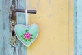 Handmade fabric heart hanging on an old door handle for a summer