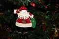 Handmade Fabric Santa Ornament hanging on a Christmas Tree