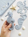 Handmade fabric stuffed toys in hand, sea life octopus and seahorse. Toy crab, octopus, starfish, seahorse, and fish