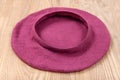 Handmade felt beret is drying on wooden table