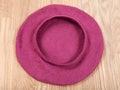 Handmade felt beret is forming on wooden table