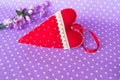 Handmade felt heart - red felt heart with beads and lace on a purple background