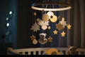 Handmade felt toys above the newborn crib with light garland in the night. Baby crib mobile, first baby eco-friendly toys, cozy