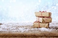 handmade gift boxes over snowy wooden table Royalty Free Stock Photo