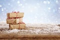 handmade gift boxes over snowy wooden table Royalty Free Stock Photo