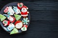 Handmade Gingerbread cookies for Christmas, New year on the plate on wooden table. Festive, sweet pastry, delicious biscuits Royalty Free Stock Photo