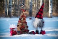 Handmade gnome with Christmas tree and chickadee in the winter forest Royalty Free Stock Photo