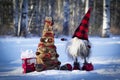 Handmade gnome with decorated Christmas tree in the winter forest Royalty Free Stock Photo
