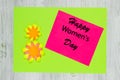 Handmade greeting card made of colored paper and wish Happy Women`s Day. Flat lay