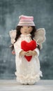 Handmade toy angel in white dress with red heart and hat