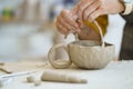 Handmade occupation for relax after work. Closeup of female hands working with raw clay material Royalty Free Stock Photo