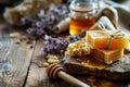 Handmade honey soap bars with a jar, honeycomb and fresh lavender flowers on a rustic wooden table background, natural Royalty Free Stock Photo