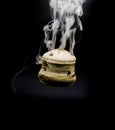 handmade incense bowl hanging with smoke isolated on black background