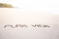 Handmade inscription on the sand of a beach with the phrase pure life Royalty Free Stock Photo