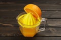 Handmade juice, juicer for citrus fruits squeeze fresh juice from halves of oranges Royalty Free Stock Photo
