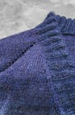 Handmade knitted products. Knitted fabric made of dark threads. Woman pullover Royalty Free Stock Photo