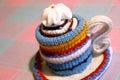 Handmade knitted striped cup of tea