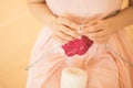 HAndmade knitting hobby. a woman knits on needles. pink and white toned stylish photo. Horizontal composition