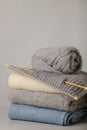 Handmade, knitting and woolen thread. Pile of knitted clothes bl