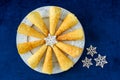 Handmade Krumkake waffle cookies on a round white plate with a snowflake pattern, decorative snowflakes, on a dark blue background Royalty Free Stock Photo