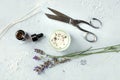 Handmade lavender scented candle with essential oil, flowers, wax, wicks, and scissors, flat lay, overhead shot Royalty Free Stock Photo