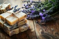 Handmade lavender soap bars with fresh flowers on a rustic wooden table background, natural skincare routine concept Royalty Free Stock Photo