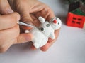 Handmade manufacture of a small toy snowman. Preparations for the celebration of Christmas.