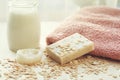 Handmade milk and honey soap bar, soft towel, luffa, oat flakes and bottle of milk shampoo Royalty Free Stock Photo