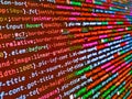 Handmade multicolor knitting wool texture background. Mobile app building. Coding script text on screen. Modern binary code close- Royalty Free Stock Photo