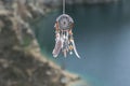 Handmade native american dream catcher on background of rocks an Royalty Free Stock Photo