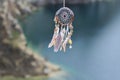 Handmade native american dream catcher on background of rocks an