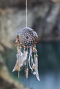 Handmade native american dream catcher on background of rocks an Royalty Free Stock Photo