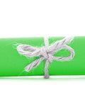 Handmade natural cord bow tied on green paper roll isolated Royalty Free Stock Photo