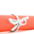 Handmade natural rope node tied on orange paper tube isolated Royalty Free Stock Photo