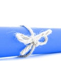 Handmade natural string knot tied on blue paper tube isolated Royalty Free Stock Photo