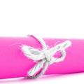 Handmade natural string knot tied on pink paper roll isolated Royalty Free Stock Photo