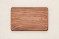 Handmade North American black walnut wooden chopping board on sackcloth. Walnut wood chopping board texture.