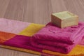 Handmade olive oil soap with colorful towels on table Royalty Free Stock Photo