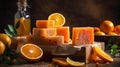 Handmade orange soap with fresh oranges and leaves on wooden background. Atmospheric beautiful spa background