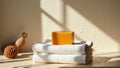 Handmade orange soap on white towels in sunlit bathroom setting Royalty Free Stock Photo