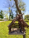 handmade original bird feeder hanging on a tree Royalty Free Stock Photo