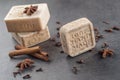 Handmade ornamental soaps with cinnamons and anise on black background, product of cosmetics and body care