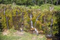 Handmade outdoor waterfall with many streams and vegetation