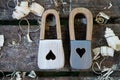 Handmade padlock wooden toy. On the wooden background with wooden shavings. Beautiful keyhole in the shape of hearts and Royalty Free Stock Photo